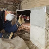 technician looking into crawl space